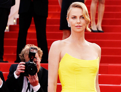 Charlize Theron in a yellow red carpet dress.